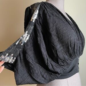 Free People short sleeved shrug with sequin trim on shoulders